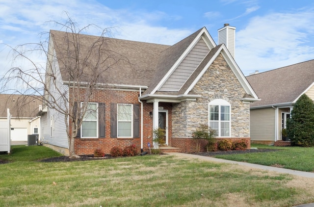 184 Whitman Aly, Clarksville, TN 37043 - view of front of home with cooling unit, stone siding, a chimney, a shingled roof, and a front yard