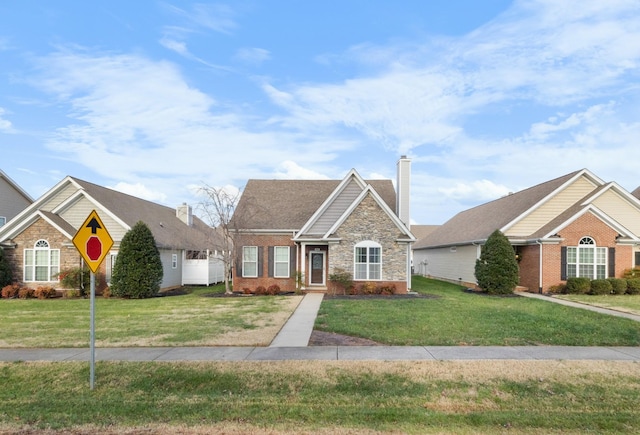 184 Whitman Aly, Clarksville, TN 37043 - view of front of property featuring a front yard, a chimney, stone siding, and brick siding