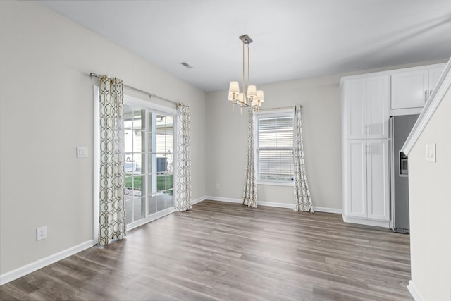 184 Whitman Aly, Clarksville, TN 37043 - unfurnished dining area featuring visible vents, wood finished floors, a chandelier, and baseboards