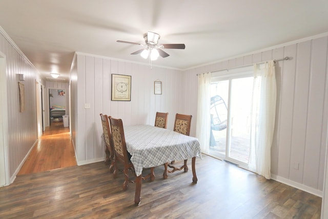 dining area with wood finished floors, ceiling fan, crown molding, and baseboards