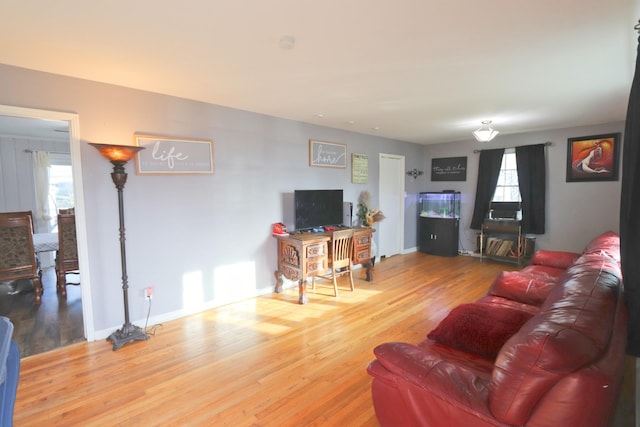 living room featuring wood finished floors and baseboards