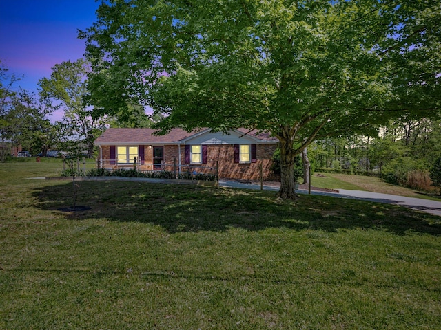 view of front facade featuring a lawn and covered porch