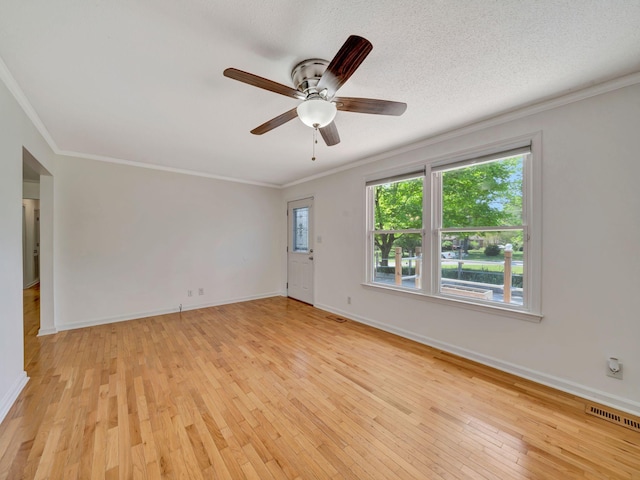 unfurnished room featuring visible vents, a ceiling fan, crown molding, and light wood finished floors
