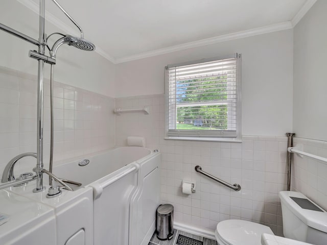 bathroom with tile walls, a washtub, toilet, and crown molding
