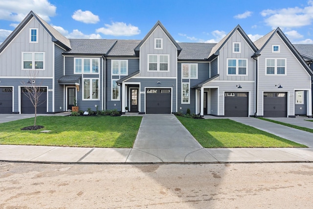 view of property featuring a garage, board and batten siding, a front yard, and concrete driveway