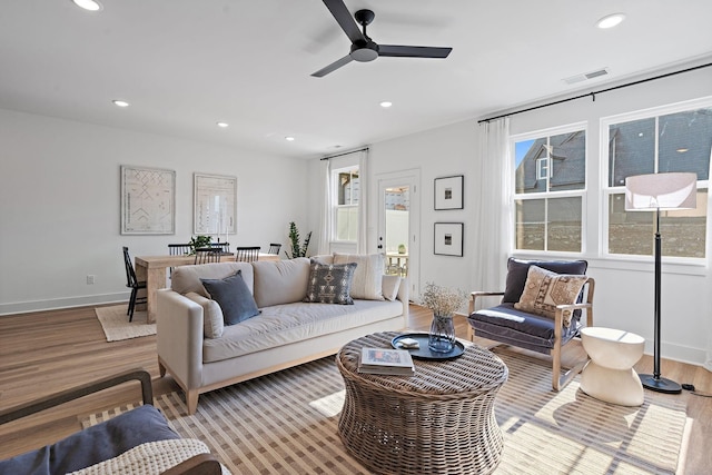 living room featuring visible vents, ceiling fan, light wood-style floors, and recessed lighting