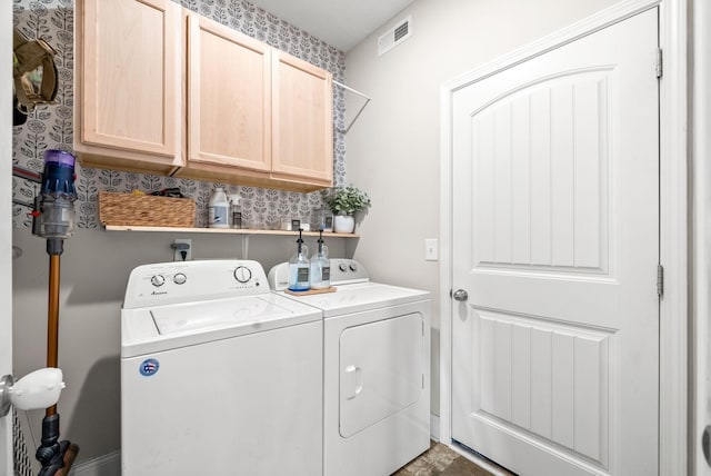 laundry room featuring cabinet space, visible vents, and washing machine and dryer