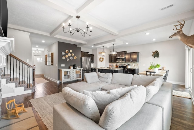 living room featuring dark wood-style flooring, a chandelier, stairs, baseboards, and visible vents