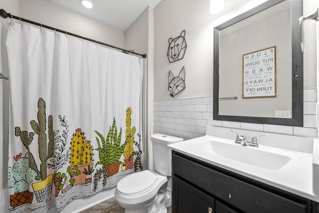 bathroom featuring toilet, tile walls, curtained shower, and vanity