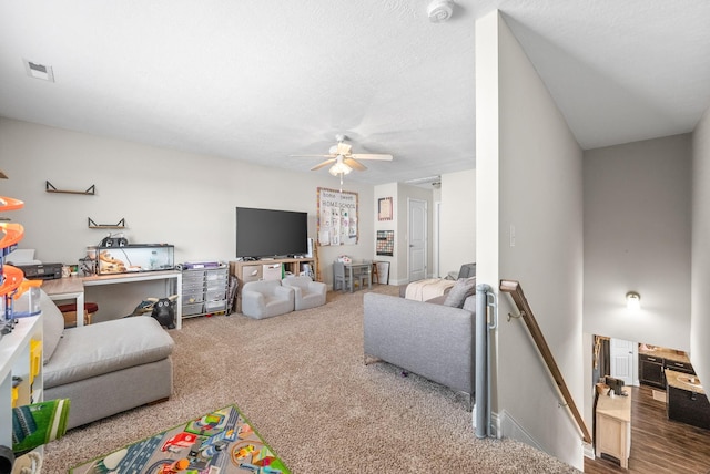 living area with carpet floors, a ceiling fan, and visible vents