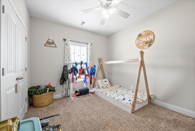 bedroom featuring carpet floors, ceiling fan, visible vents, and a closet