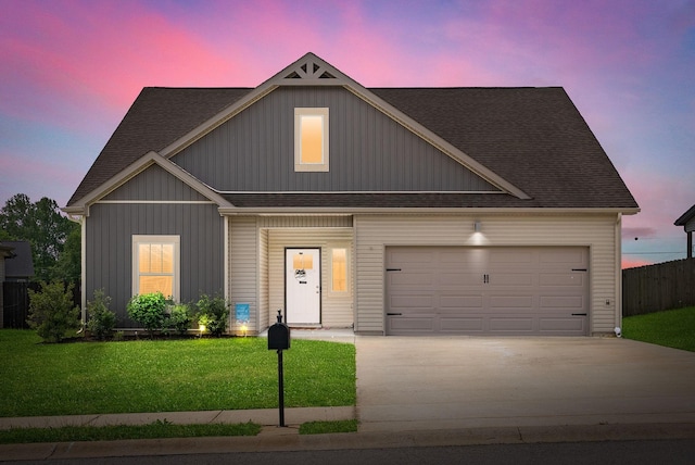 craftsman house featuring a garage, a shingled roof, driveway, and a front lawn
