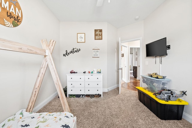 carpeted bedroom with baseboards and a ceiling fan