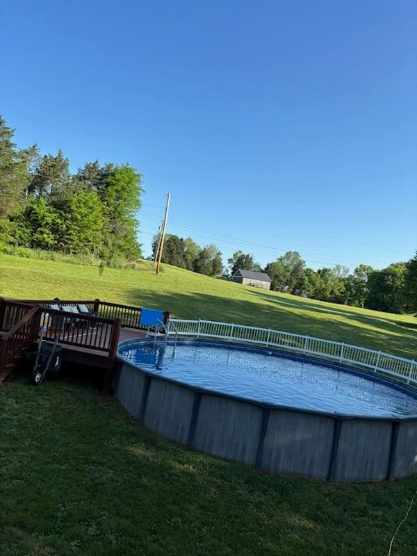 pool with a yard and a wooden deck