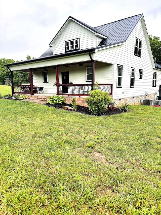 view of front of property with metal roof, crawl space, and a front yard