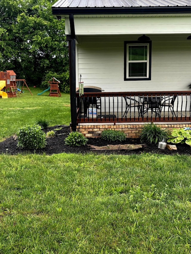 exterior space featuring covered porch, a playground, and a lawn