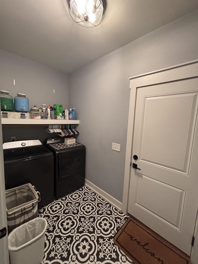clothes washing area featuring separate washer and dryer and baseboards