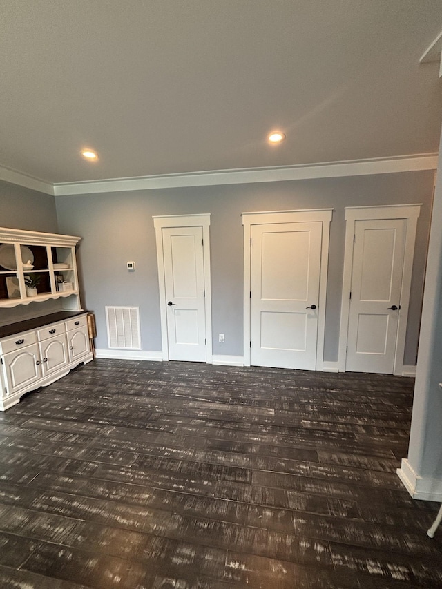 unfurnished living room featuring ornamental molding, wood finished floors, baseboards, and recessed lighting