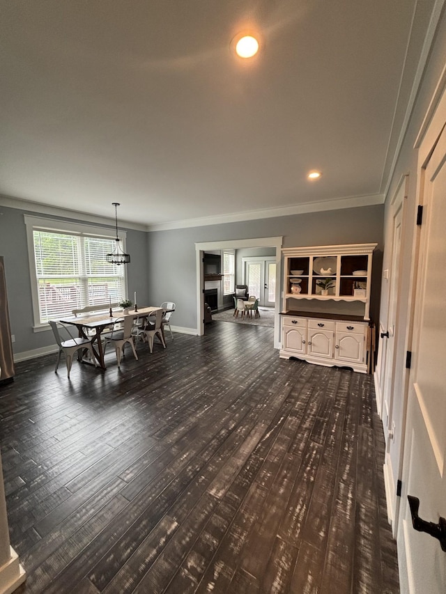 dining area with dark wood-style flooring, crown molding, baseboards, a chandelier, and recessed lighting