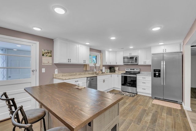 74 Farmer Rd, Crossville, TN 38571 - kitchen with appliances with stainless steel finishes, light wood-style floors, recessed lighting, and white cabinets