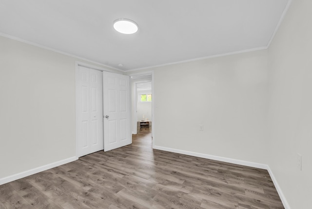 74 Farmer Rd, Crossville, TN 38571 - unfurnished bedroom featuring ornamental molding, wood finished floors, and baseboards