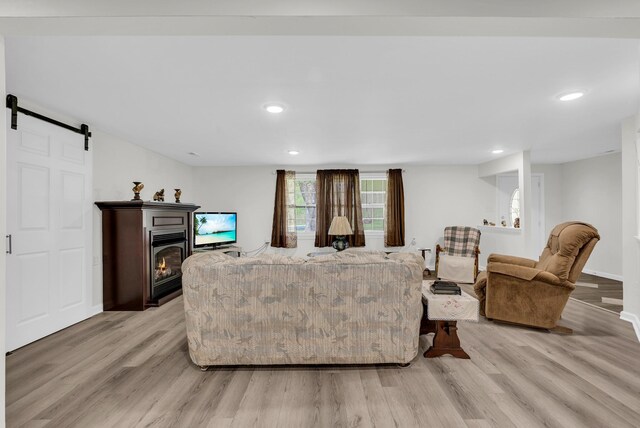 74 Farmer Rd, Crossville, TN 38571 - living area featuring a barn door, recessed lighting, light wood-style flooring, and a glass covered fireplace
