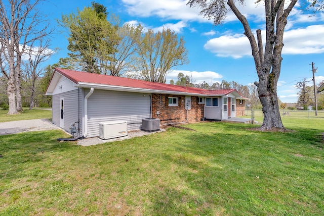 74 Farmer Rd, Crossville, TN 38571 - back of property featuring fence, central AC unit, metal roof, and a yard