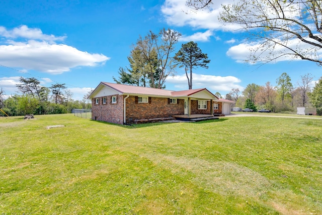 74 Farmer Rd, Crossville, TN 38571 - single story home with a front lawn, metal roof, driveway, brick siding, and an attached garage