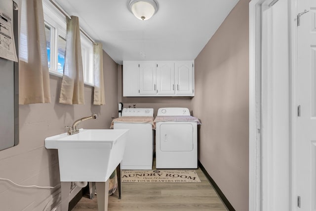 74 Farmer Rd, Crossville, TN 38571 - laundry area featuring independent washer and dryer, light wood-style flooring, a sink, baseboards, and cabinet space