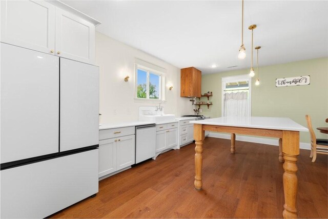 153 Lewis Rd, Morrison, TN 37357 - kitchen with light wood-type flooring, white appliances, plenty of natural light, and a sink