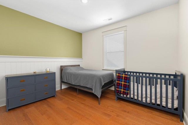 153 Lewis Rd, Morrison, TN 37357 - bedroom featuring wood finished floors, visible vents, and wainscoting