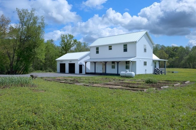 153 Lewis Rd, Morrison, TN 37357 - view of front of house featuring a garage, a front lawn, driveway, and metal roof