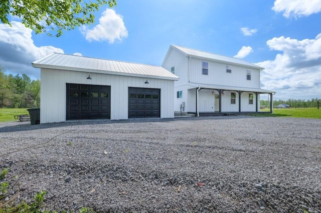 153 Lewis Rd, Morrison, TN 37357 - modern farmhouse style home with a porch, driveway, metal roof, and an outbuilding