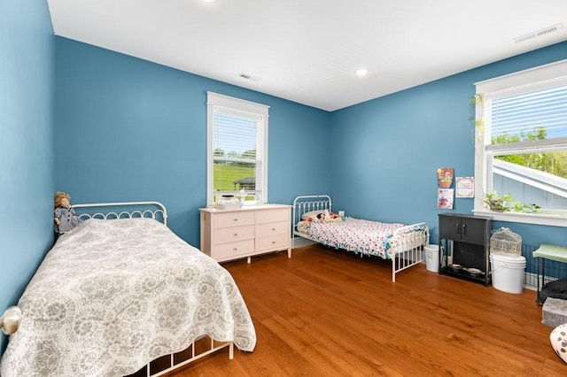 153 Lewis Rd, Morrison, TN 37357 - bedroom with wood finished floors, visible vents, and multiple windows