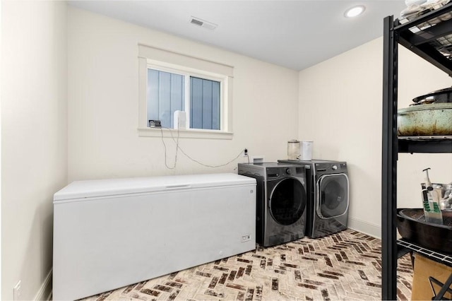 153 Lewis Rd, Morrison, TN 37357 - laundry area featuring visible vents, laundry area, washer and clothes dryer, recessed lighting, and brick floor