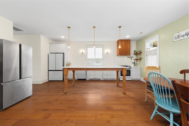 153 Lewis Rd, Morrison, TN 37357 - kitchen featuring electric range, wood finished floors, visible vents, and freestanding refrigerator