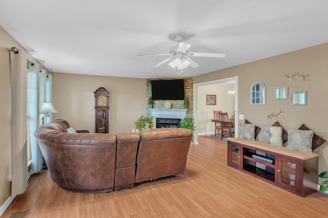 1368 Jason Cir, Ashland City, TN 37015 - living room featuring a fireplace, a ceiling fan, and light wood-style flooring