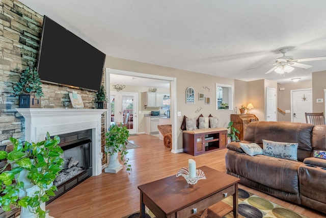 1368 Jason Cir, Ashland City, TN 37015 - living area with light wood finished floors, a ceiling fan, a textured ceiling, and a fireplace