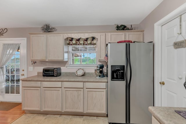 1368 Jason Cir, Ashland City, TN 37015 - kitchen with light brown cabinetry, stainless steel refrigerator with ice dispenser, light countertops, and plenty of natural light