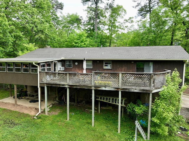 back of house with cooling unit, a patio, a wooden deck, a shingled roof, and a sunroom