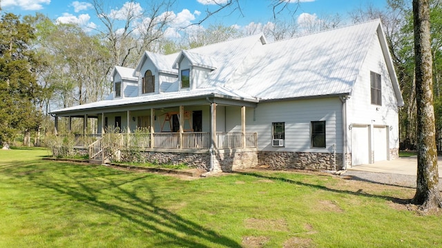view of front facade with a porch, a front lawn, a garage, driveway, and stone siding