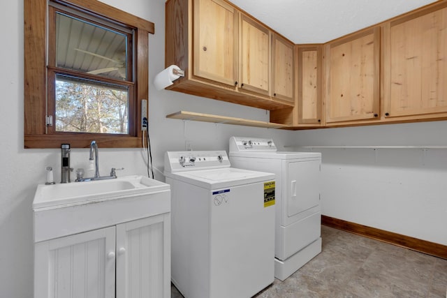 laundry area featuring cabinet space, independent washer and dryer, and baseboards