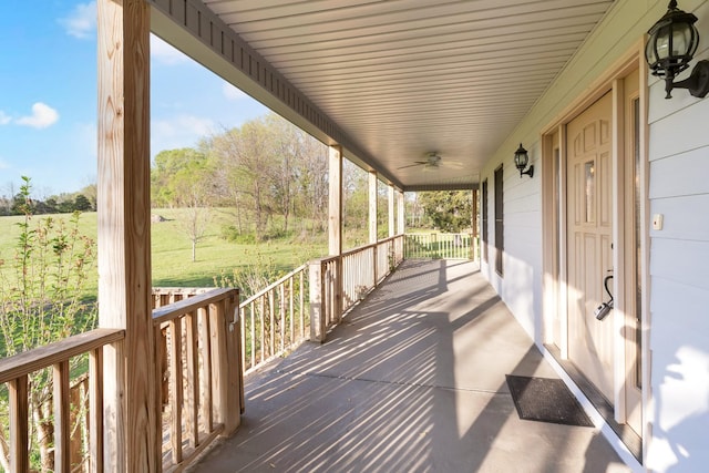 wooden terrace featuring a ceiling fan and covered porch
