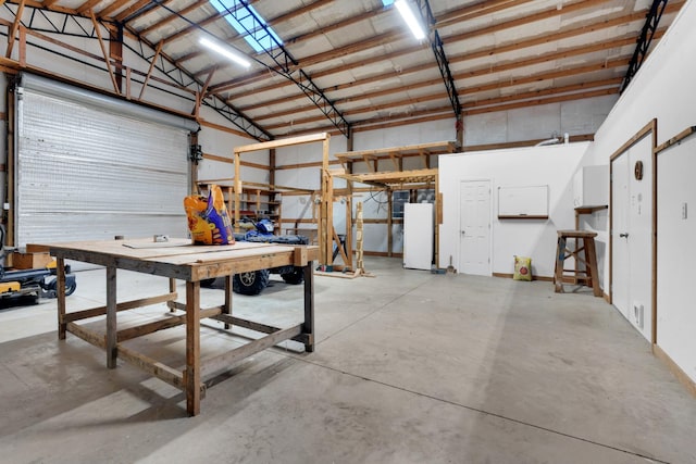 garage featuring a workshop area and refrigerator