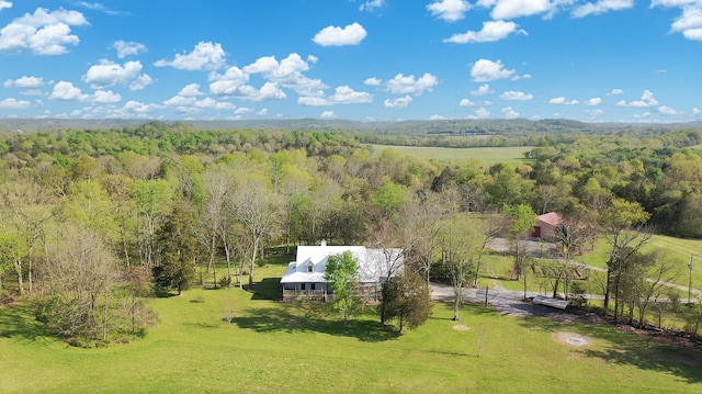 birds eye view of property with a view of trees