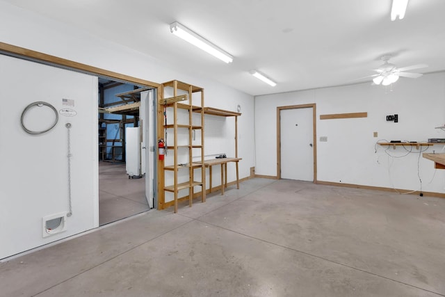garage with a ceiling fan and freestanding refrigerator
