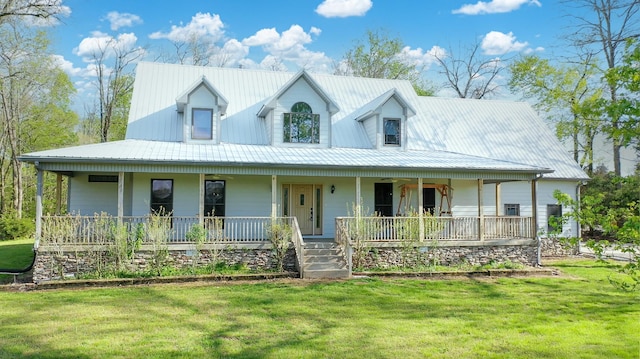 farmhouse inspired home featuring metal roof, a front yard, and covered porch