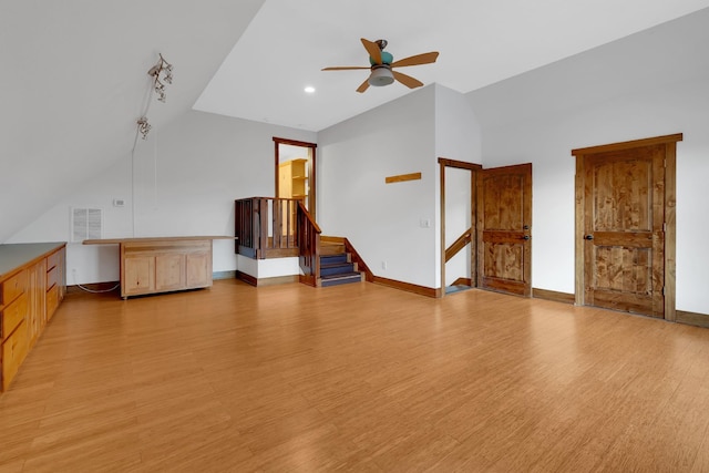 additional living space featuring stairway, visible vents, baseboards, light wood-type flooring, and a ceiling fan
