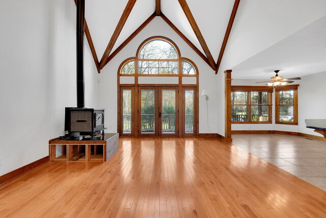 foyer entrance with high vaulted ceiling, wood finished floors, a ceiling fan, and plenty of natural light