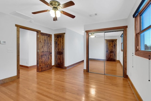 unfurnished bedroom with visible vents, a ceiling fan, light wood-style flooring, and baseboards